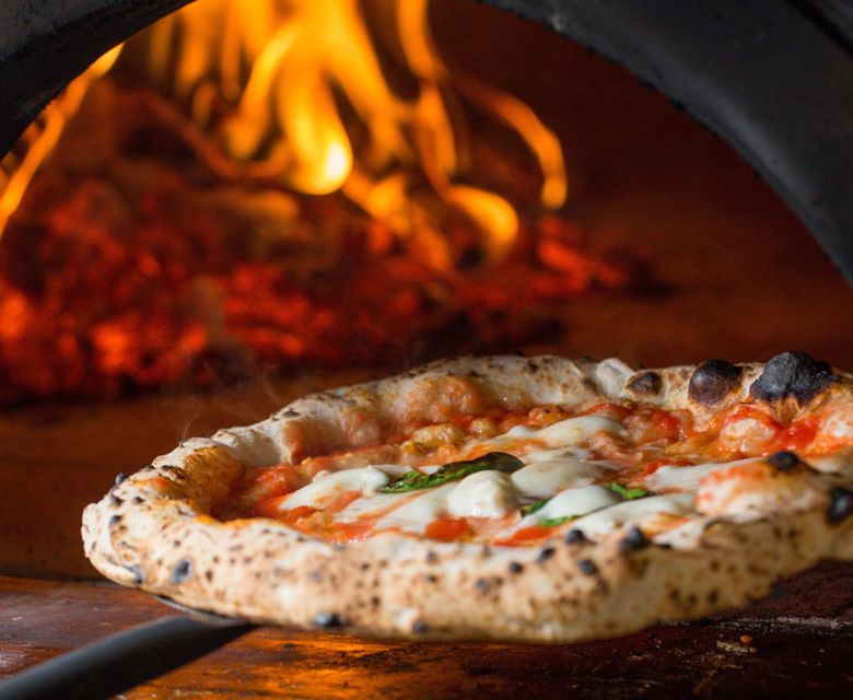 Margarita pizza coming out of the oven