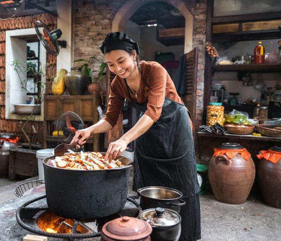 Woman cooking on open fire