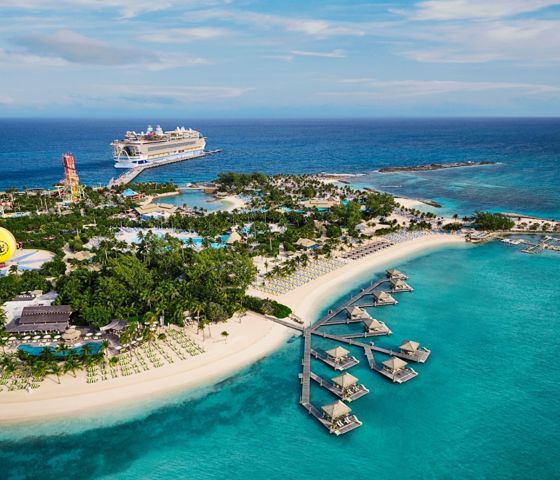 Icon of the Seas, ship seen in background docked at Perfect Day at CocoCay Island