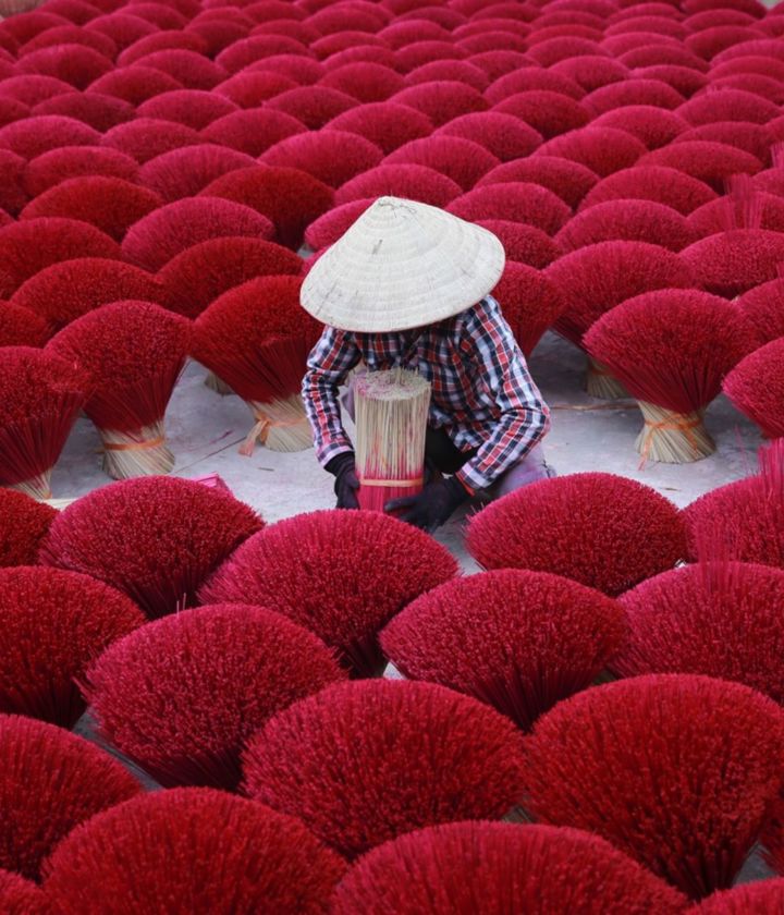 Asia Vietnam woman making red incense 