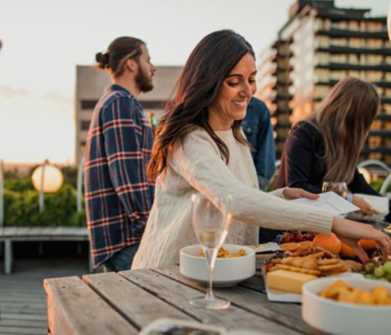 Woman reaching for food from platter