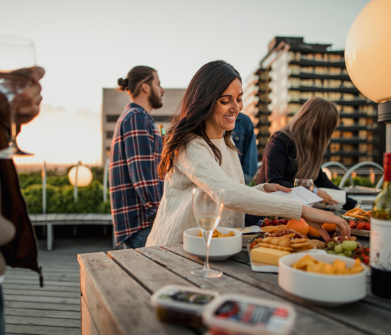 Person reaching for food from platter.