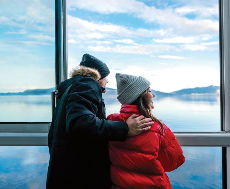 Ovation of the Seas, couple at windows, wearing winter coats